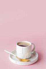 Cup of hot coffee on color background