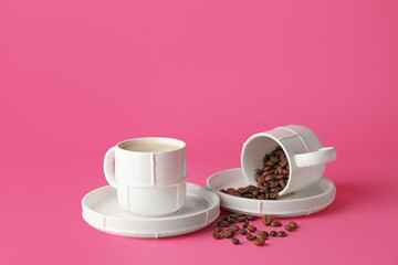 Cups with coffee on color background