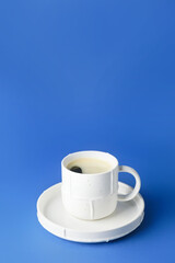 Cup of hot coffee on color background