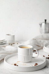 Cup of hot coffee on table