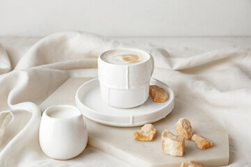 Cup of hot coffee on table