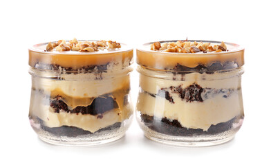 Delicious cupcakes in jars on white background