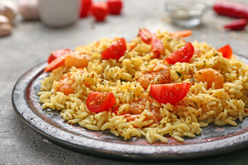 Plate with tasty pilaf on table, closeup