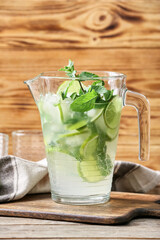 Jug of fresh mojito on table