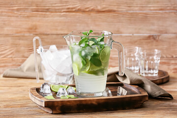 Jug of fresh mojito on table