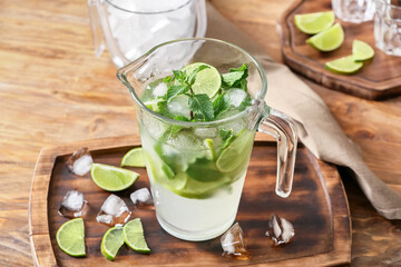 Jug of fresh mojito on table