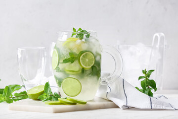 Jug of fresh mojito on table