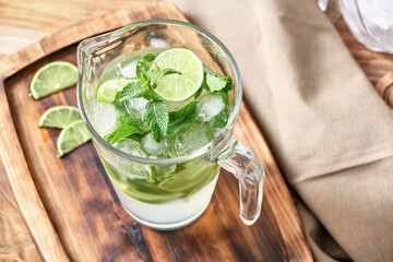 Jug of fresh mojito on table
