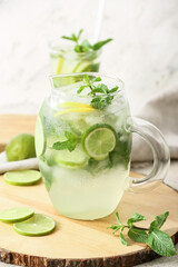 Jug of fresh mojito on table
