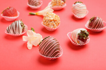 Tasty strawberry dipped in chocolate and flowers on color background