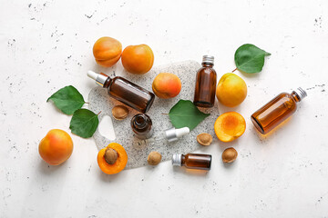 Bottles of apricot essential oil on white background