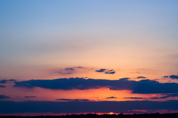 Sunset sky with orange and blue tones in horizon