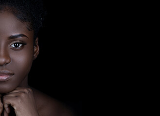 close up of beautiful young black woman with beautiful skin and makeup looking at camera