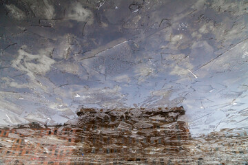 Vintage apartment house reflected in freezing Fontanka river