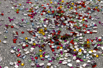 Colorful sequins on a Silver glitter background