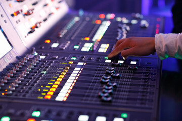 sound engineer working with sound mixing console