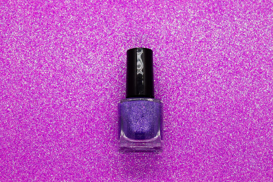 Purple nail polish on a glittery background