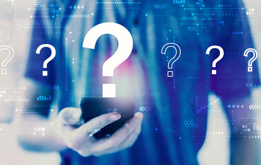 Question marks with young man using a smartphone