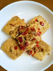 braised stink bean curd with red pepper on the white plate