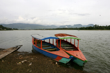 Several boats in Situ Cileunca, Pangalengan, West Java, Indonesia. The atmosphere of Lake Cileunca with a row of boats leaning back