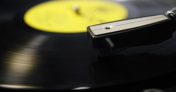 Record player needle lowering and then moving across the record