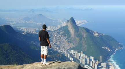 man admiring the look of the top of the Gavea stone ( pedra da gavea ) in Rio de Janeiro.