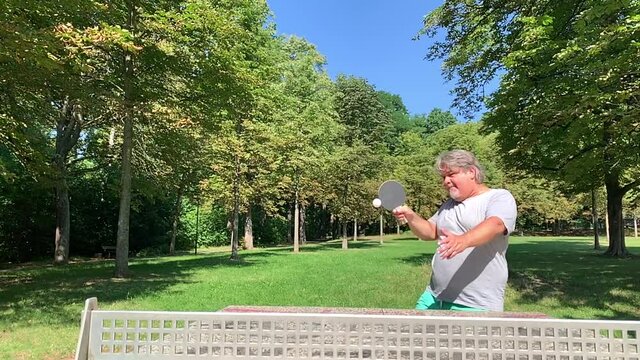 Man topspin forehand in tennis table in a slow motion video.