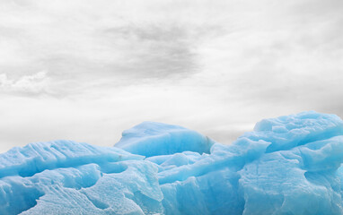 Fototapeta na wymiar Closeup blue iceberg and volcanic ash at a glacial lagoon in Iceland