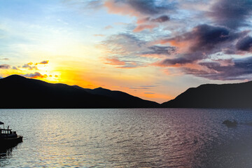 Fototapeta premium Landscape clouds sunrise sky and silhouette of mountain on lake morning background