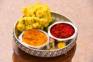 Turmeric and kumkum powder in silver bowl for pooja