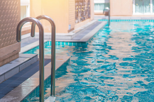 blue swimming pool at hotel with stair