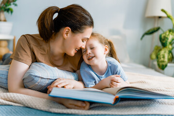 mother reading a book to her daughter
