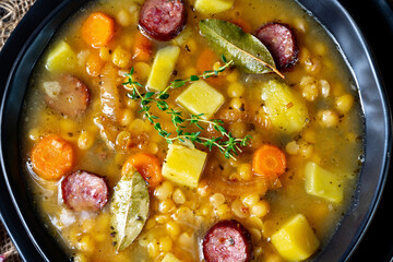 Rustic pea soup with bacon and sausages