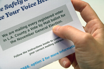 Hand holding a voting information paper - All L.A. County residents vote by mail