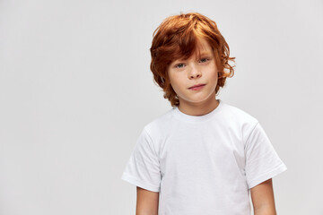 portrait of redhead boy freckles on face white t-shirt cropped view 