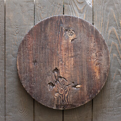 round wooden plate on old wooden background