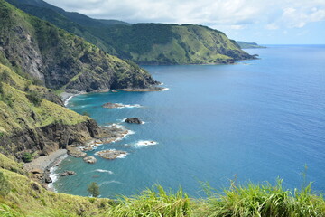 Rock formation and sea water at mountain view white beach resort