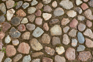 The floor background is made of rounded stones. Pebble cobblestone