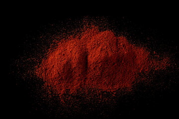 Fototapeta na wymiar Red paprika, pepper powder pile isolated on black background, top view