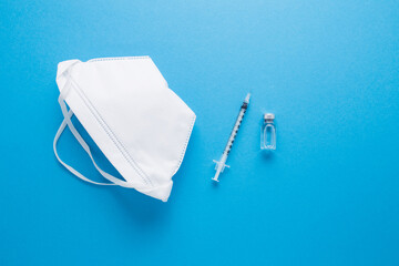 Closeup vaccine with a syringe on a blue background.