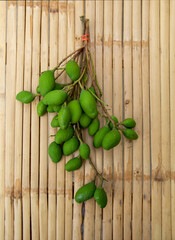 Bunch of green mango,on bamboo background, top view