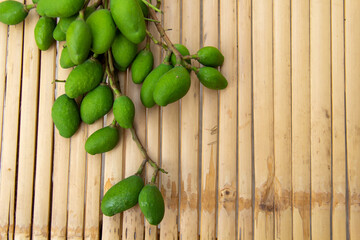 Bunch of green mango,on bamboo background, top view