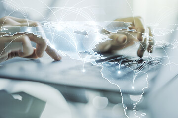 Double exposure of abstract digital world map with connections and hand typing on computer keyboard...