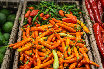Basket with red and green chilli pepper in the shop .