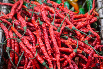 Basket with red and green chilli pepper in the shop