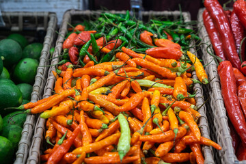 Basket with red and green chilli pepper in the shop .