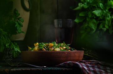 Vegetable roast eggplant and potatoes in a clay plate (ketsa). Homemade healthy food in a rustic style.