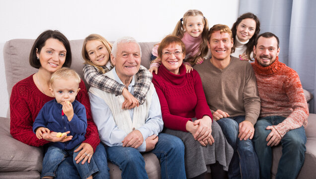 Family members making family photo during reunion party on sofa