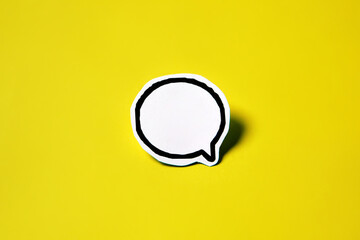 A Blank speech bubble on white paper isolated on yellow paper background with drop shadow. COPY...