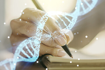 Creative light DNA illustration and woman hand writing in diary on background, science and biology concept. Multiexposure